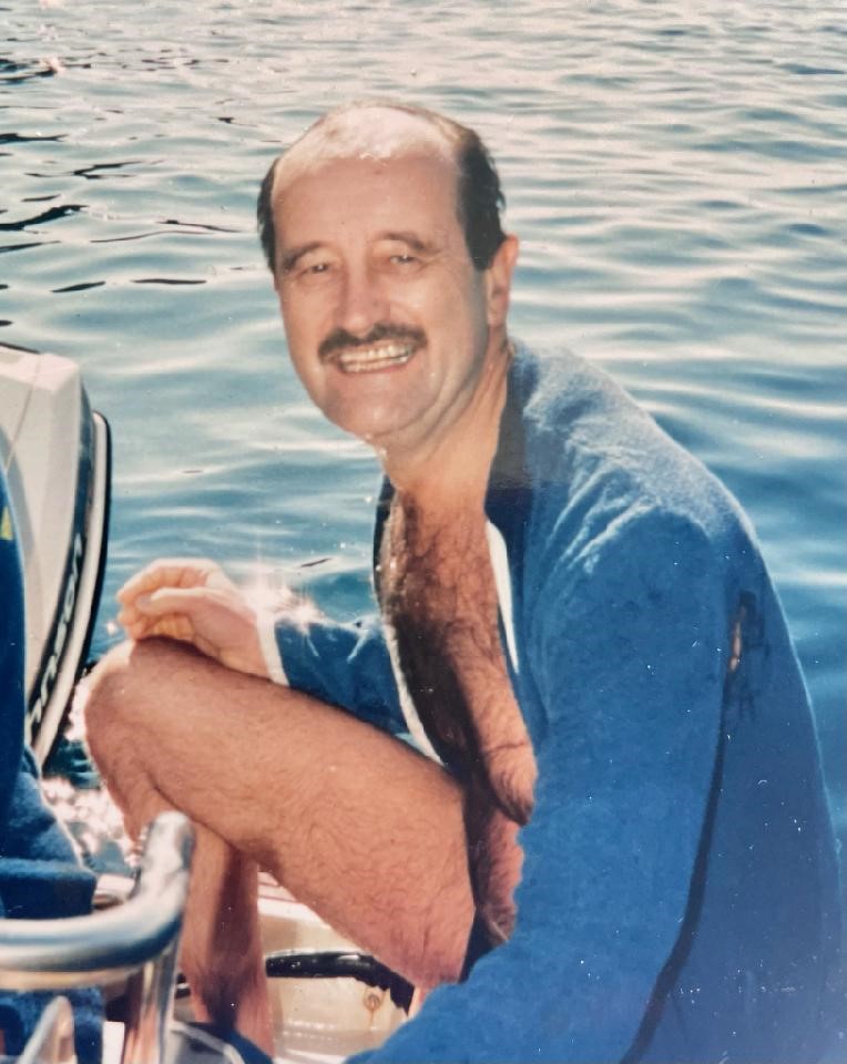 An image of Jim Reynolds, a smiling man in his 40's, with a moustache on a boat