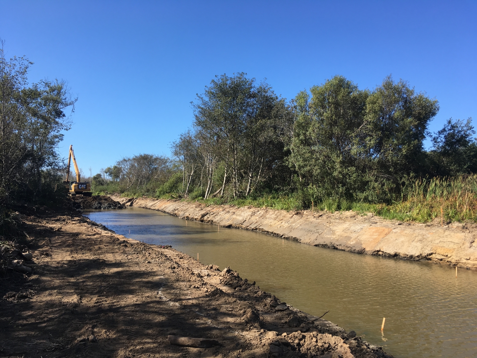Upper Reach Excavation - Looking downstream from Pescadero Creek Rd. Bridge, the excavator completes final excavation of the Butano channel.September 2019