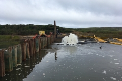 Initial dewatering of the work area behind sheet pile dam, July 2019