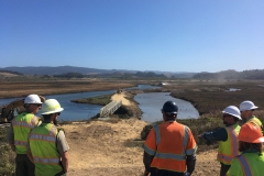 Hanford ARC staff look over at the pedestrian bridge where a new water control feature was installed to help improve the water quality of the side channel. October 2019