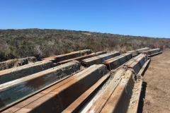 The removed sheet piles sitting in a dirt lot, waiting to be hauled away. October 2019